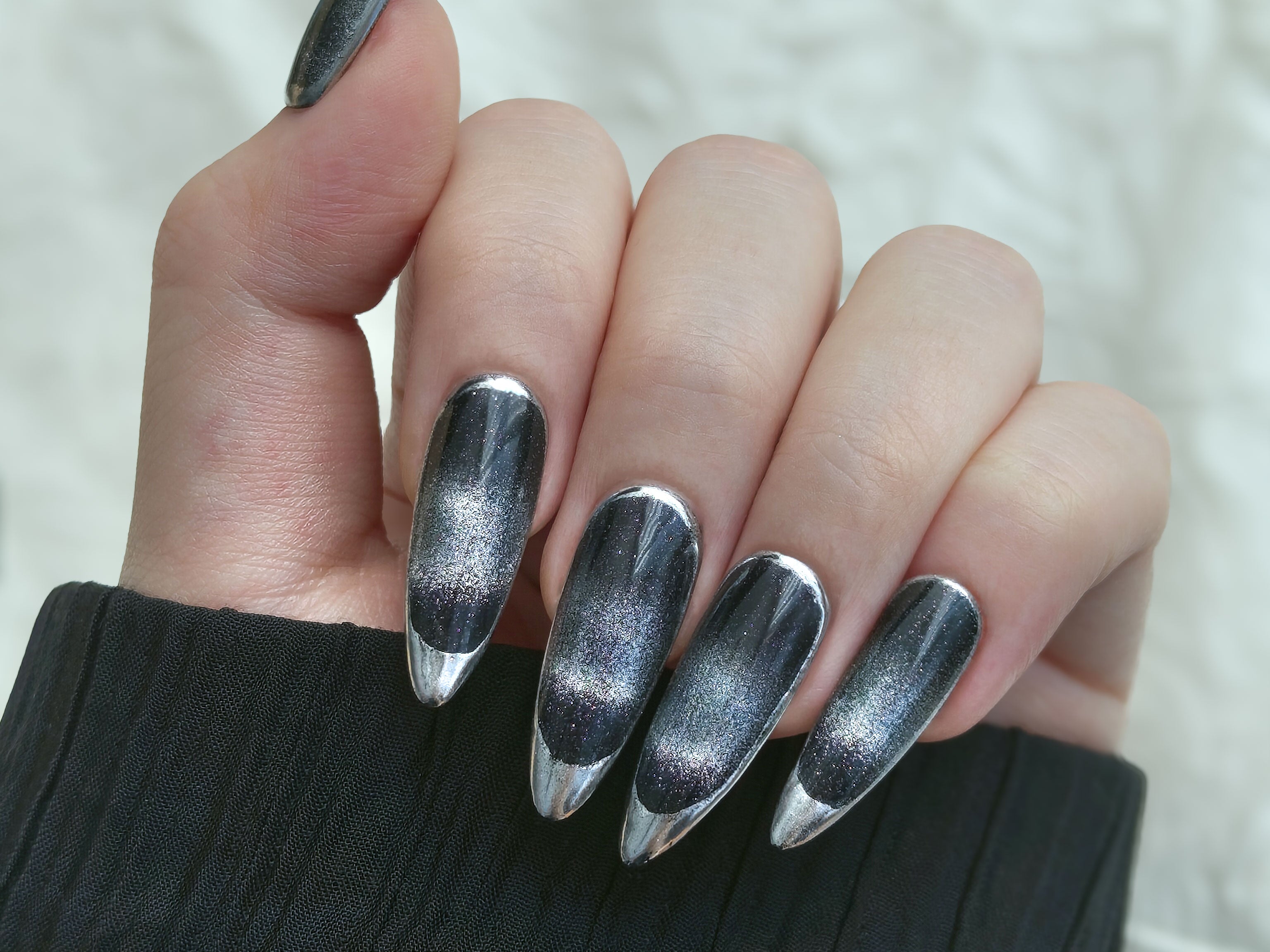 Handmade long almond French Tip Press on Nails in a velvety black base and glimmering silver