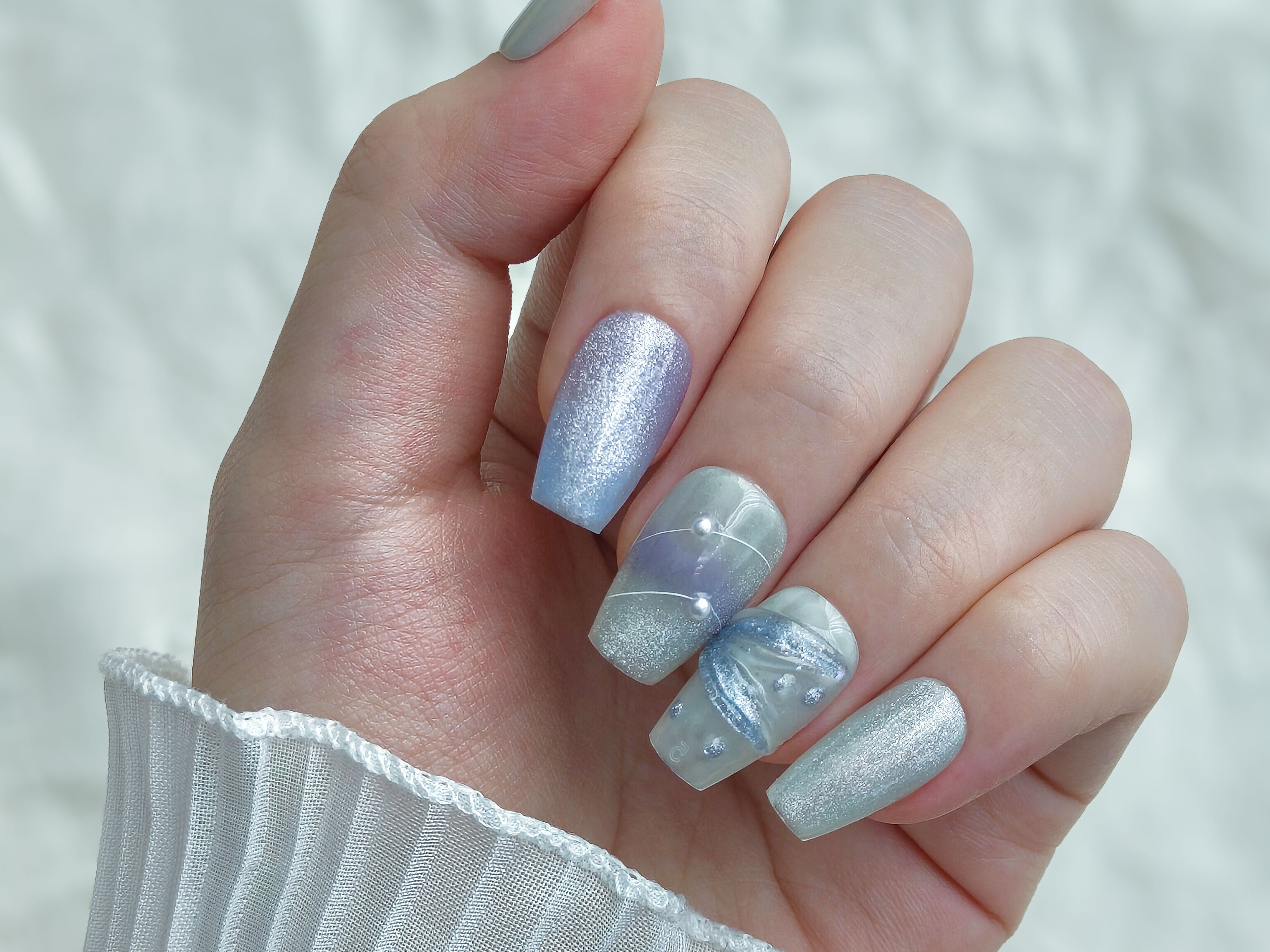 on hand photo of a Handmade Middle Coffin blue Mermaid Nails from Snaptips